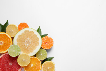 Different citrus fruits with fresh leaves on white background, top view. Space for text