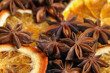 Dry orange slices and anise stars as background, closeup