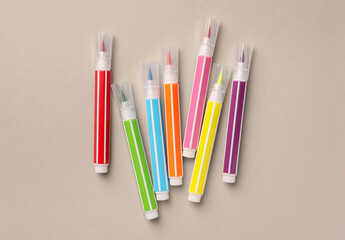 Many bright markers on light grey background, flat lay