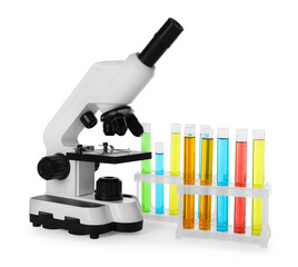 Test tubes with colorful liquids and microscope isolated on white