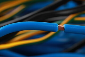 New light blue electrical wire on blurred background, closeup view
