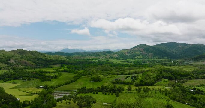 Aerial view of Agricultural land and mountains with green forest. Philippines.