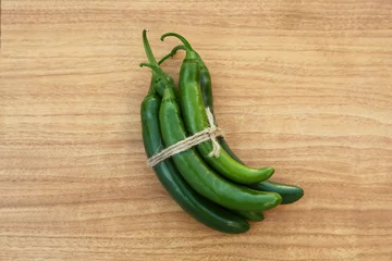 Fotobehang Chili Pepers Green ripe chili peppers on wooden table, top view  © New Africa