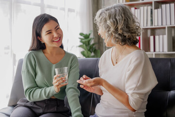Candid attractive beautiful mum sit at cozy sofa couch living room in family moment grown child kid celebrate joy good warm time kiss relationship with retired overjoy lady girl health life.