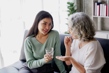Candid attractive beautiful mum sit at cozy sofa couch living room in family moment grown child kid celebrate joy good warm time kiss relationship with retired overjoy lady girl health life.