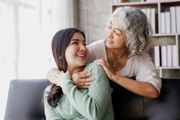 Candid attractive beautiful mum sit at cozy sofa couch living room in family moment grown child kid celebrate joy good warm time kiss relationship with retired overjoy lady girl health life.