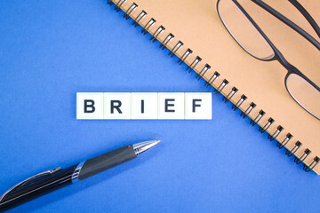 glasses, pen and book with the word brief. simple or easy concepts