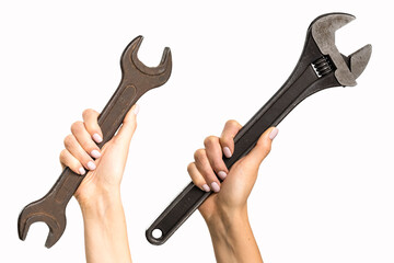 Different wrenches in a woman's hand on a white background. A tool with signs of wear in a woman's hand.