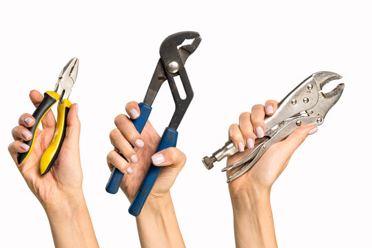 Different pliers in a woman's hand on a white background. A tool with signs of wear in a woman's hand.
