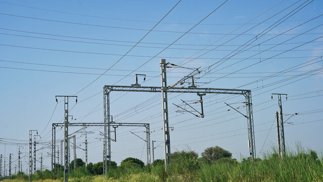 Railway Electric Cables And Poles In India. Overhead Power Lines To Power Electric Rails. Catenary Wires, Feeder, Dropper. Many Railway Pole