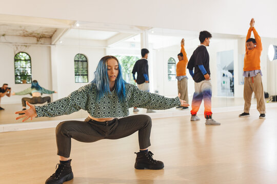 Image of diverse female and male hip hop dancers during training in dance school
