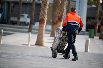 Man delivering beer kegs in Malaga, Spain