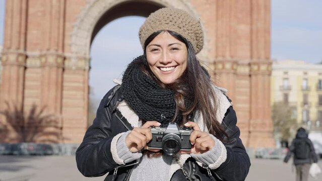 Traveling Asian Japanese woman tourist taking photo in winter vacation in Barcelona