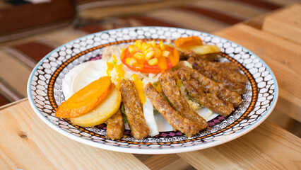 African combo plate with rice, fried cheese, grilled vegetables, peanut sauce and other traditional...