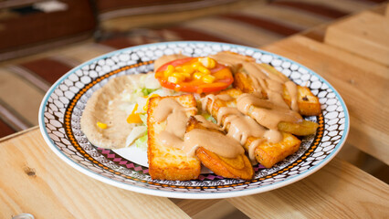 African combo plate with rice, fried cheese, grilled vegetables, peanut sauce and other traditional...