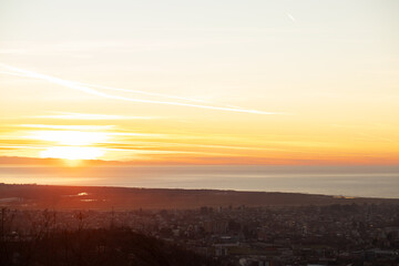 Naklejka na ściany i meble city sunset, evening sunrise, sea view, aerial cityscape in sunlight