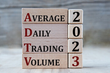 AVERAGE DAILY TRADING VOLUME 2023 - words on wooden blocks on gray background