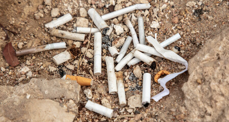 Smoked cigarettes on the ground like garbage.