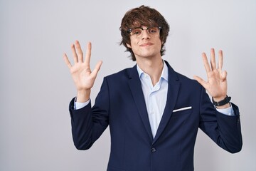 Hispanic business young man wearing glasses showing and pointing up with fingers number nine while smiling confident and happy.
