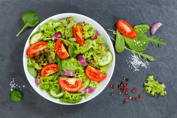Mixed salad with fresh tomatoes healthy eating food from above on a slate
