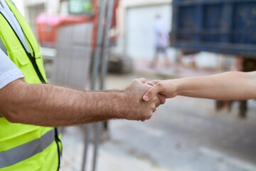 Middle age man architect shake hands at street