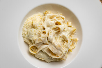 delicious pasta with 4 types of cheese and sauce on a plate from a restaurant
