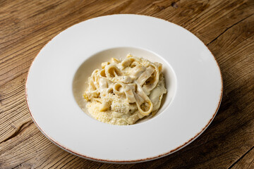 delicious pasta with 4 types of cheese and sauce on a plate from a restaurant

