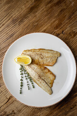 a delicious dish of sea bream on a plate prepared in a restaurant.
