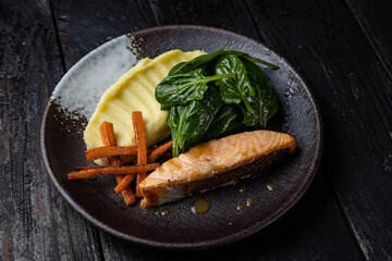 delicious salmon dish on a plate prepared in a restaurant.
