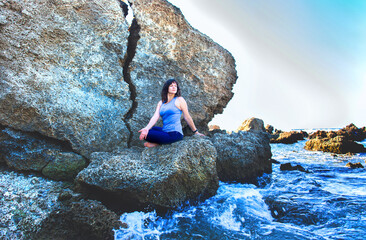 Woman doing yoga on a beach