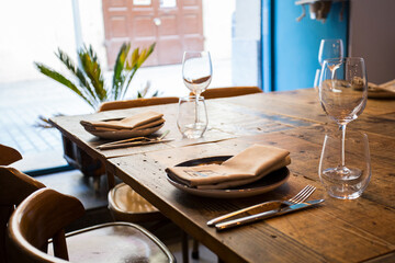Elegant restaurant table with cutlery, crockery and glasses.