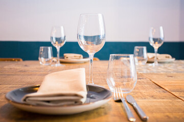 Elegant restaurant table with cutlery, crockery and glasses.
