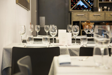 Elegant restaurant table with cutlery, crockery and glasses.
