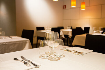 Elegant restaurant table with cutlery, crockery and glasses.
