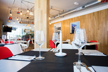 Elegant restaurant table with cutlery, crockery and glasses.