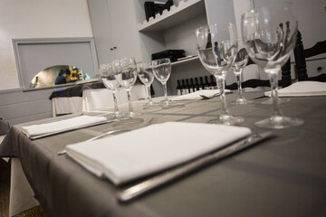 Elegant restaurant table with cutlery, crockery and glasses.