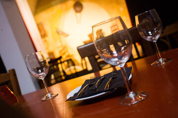 Elegant restaurant table with cutlery, crockery and glasses.