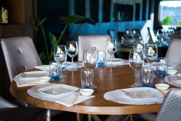 Elegant restaurant table with cutlery, crockery and glasses.