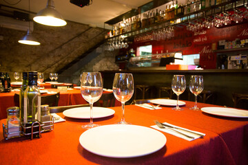 Elegant restaurant table with cutlery, crockery and glasses.