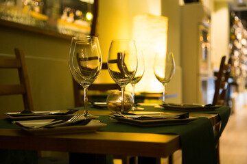 Elegant restaurant table with cutlery, crockery and glasses.