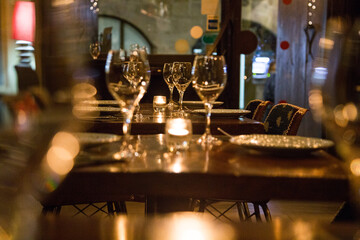 Elegant restaurant table with cutlery, crockery and glasses.