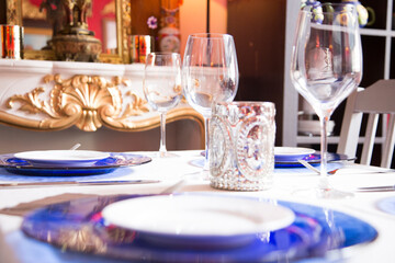 Elegant restaurant table with cutlery, crockery and glasses.