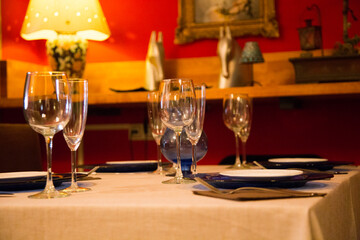 Elegant restaurant table with cutlery, crockery and glasses.