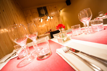 Elegant restaurant table with cutlery, crockery and glasses.