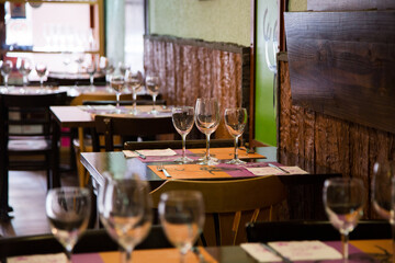 Elegant restaurant table with cutlery, crockery and glasses.