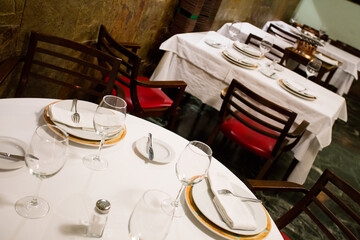 Elegant restaurant table with cutlery, crockery and glasses.