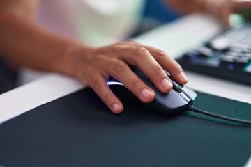 Young beautiful hispanic woman using computer mouse at street