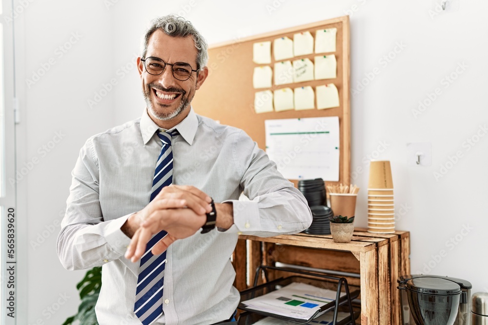 Sticker Middle age grey-haired man business worker smiling confident looking watch at office