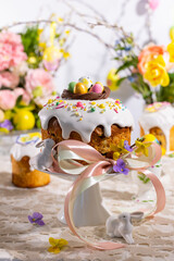 Festive Easter table setting. Easter cake, Easter Eggs, Flower arrangements and home decorations for holiday.