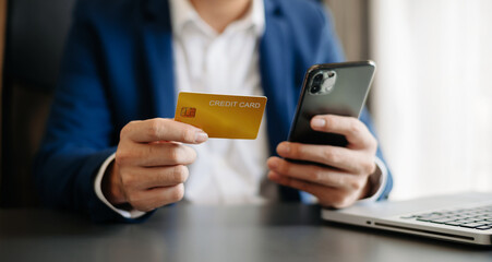 businessman hand using smart phone, tablet payments and holding credit card online shopping, omni channel, digital tablet docking keyboard computer